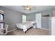 Bedroom featuring a bed, study area, and built-in shelves, with a calm and inviting ambiance at 100 Rabbits Run, Fayetteville, GA 30214