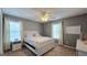 Cozy bedroom with neutral walls, ceiling fan, and windows with light-filtering curtains at 100 Rabbits Run, Fayetteville, GA 30214