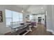 Dining area featuring a wooden table with bench seating, adjacent to a bright, open kitchen at 100 Rabbits Run, Fayetteville, GA 30214