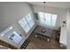 Sun-filled dining area with a large table, modern lighting, and bright windows at 100 Rabbits Run, Fayetteville, GA 30214