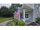 Inviting front porch with swing and American flag at 100 Rabbits Run, Fayetteville, GA 30214