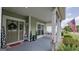Inviting front porch with swing, patriotic decor, and neutral tones provides a warm welcome at 100 Rabbits Run, Fayetteville, GA 30214