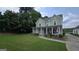 Charming two-story home with a welcoming front porch, manicured lawn, and lovely landscaping at 100 Rabbits Run, Fayetteville, GA 30214