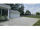 Attached two-car garage with extended driveway and a landscaped yard at 100 Rabbits Run, Fayetteville, GA 30214