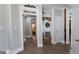A hallway with a small built-in bench leads to a bedroom. A welcome sign hangs above the entrance at 100 Rabbits Run, Fayetteville, GA 30214