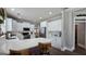 The kitchen features white cabinets, stainless steel appliances, and seating at the island at 100 Rabbits Run, Fayetteville, GA 30214