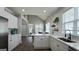Bright kitchen features white cabinets, an island, stainless steel appliances, and hardwood flooring at 100 Rabbits Run, Fayetteville, GA 30214