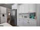 Kitchen features stainless steel refrigerator, white cabinets, modern backsplash, and ample counter space at 100 Rabbits Run, Fayetteville, GA 30214