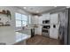 Bright, modern kitchen with white cabinetry, stainless steel appliances, and quartz countertops at 100 Rabbits Run, Fayetteville, GA 30214