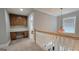 Second floor landing featuring a built-in desk and cabinetry, and adjacent to a bedroom at 100 Rabbits Run, Fayetteville, GA 30214