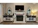 Elegant living room with fireplace, TV, decorative accents, and stylish cabinets at 100 Rabbits Run, Fayetteville, GA 30214
