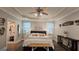 Bright primary bedroom boasts a king bed, accent lighting, and an en suite bath at 100 Rabbits Run, Fayetteville, GA 30214