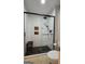 Modern tiled shower featuring glass door, rainfall showerhead, and built in bench at 100 Rabbits Run, Fayetteville, GA 30214