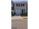Charming townhouse with a one-car garage, black shutters, and a well-manicured lawn at 11992 Fuller St, Hampton, GA 30228