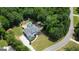 Aerial shot of a luxury home with a private pool, surrounded by a lush yard and trees in a community at 265 Beverly Farms Dr, Sharpsburg, GA 30277