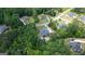 An aerial view of a luxury home with a private pool nestled among mature trees in a residential neighborhood at 265 Beverly Farms Dr, Sharpsburg, GA 30277