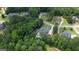 Aerial view of homes in wooded neighborhood, featuring a luxury home with a private pool surrounded by trees at 265 Beverly Farms Dr, Sharpsburg, GA 30277