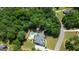 Aerial view of a spacious home with a large, wooded lot and private backyard pool at 265 Beverly Farms Dr, Sharpsburg, GA 30277