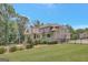 View of the home's rear exterior, manicured lawn, and fenced-in pool at 265 Beverly Farms Dr, Sharpsburg, GA 30277