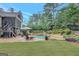 Beautifully landscaped backyard featuring an in-ground pool, patio, and manicured lawn at 265 Beverly Farms Dr, Sharpsburg, GA 30277