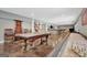 Large finished basement with an open layout that includes multiple games and a seating area at 265 Beverly Farms Dr, Sharpsburg, GA 30277