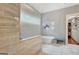 Bathroom featuring a standalone tub, a glass shower, and an adjacent walk-in closet at 265 Beverly Farms Dr, Sharpsburg, GA 30277