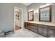 Bathroom featuring marble tile, double vanities, framed mirrors, with a walk-in closet for ample storage at 265 Beverly Farms Dr, Sharpsburg, GA 30277