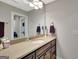 Bathroom with a vanity, large mirror, modern lighting, and neutral paint at 265 Beverly Farms Dr, Sharpsburg, GA 30277
