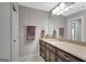 Bathroom featuring a sink with wooden cabinets, neutral colored counters, and towel racks at 265 Beverly Farms Dr, Sharpsburg, GA 30277