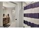Bathroom view showcasing striped shower curtain and wood vanity with decorative elements at 265 Beverly Farms Dr, Sharpsburg, GA 30277