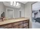 Neutral bathroom featuring a light countertop, warm wood cabinets, and a large mirror at 265 Beverly Farms Dr, Sharpsburg, GA 30277