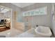 Bathroom features a standalone tub, a glass shower, and ample natural light with an adjacent bedroom at 265 Beverly Farms Dr, Sharpsburg, GA 30277