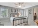 Bedroom with black metal bed, light-colored carpet and wall color, and a window with natural light at 265 Beverly Farms Dr, Sharpsburg, GA 30277
