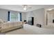 Bright bedroom with carpet, ceiling fan, dark trim, and a window with natural light at 265 Beverly Farms Dr, Sharpsburg, GA 30277