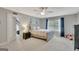 Bedroom with ceiling fan, window, carpeting, and view into bonus room at 265 Beverly Farms Dr, Sharpsburg, GA 30277