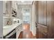 Charming butler's pantry with wine rack, stylish backsplash, and convenient access to the dining area at 265 Beverly Farms Dr, Sharpsburg, GA 30277