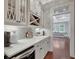 Butler's pantry featuring custom cabinets, a wine cooler, and ample counter space with stylish decor at 265 Beverly Farms Dr, Sharpsburg, GA 30277