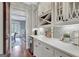 Open-concept butler's pantry with wine storage, elegant countertops, and decorative tile backsplash at 265 Beverly Farms Dr, Sharpsburg, GA 30277