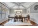Formal dining room showcasing elegant chandelier, wainscoting, and hardwood floors at 265 Beverly Farms Dr, Sharpsburg, GA 30277