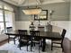 This dining room features an elegant chandelier, a large table, and wainscoting at 265 Beverly Farms Dr, Sharpsburg, GA 30277