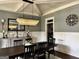 This dining room features an elegant chandelier, a large table, and wainscoting at 265 Beverly Farms Dr, Sharpsburg, GA 30277