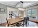 Dining room featuring hardwood floors, chandelier and view to office with glass doors at 265 Beverly Farms Dr, Sharpsburg, GA 30277