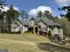 Inviting two-story home boasting stone details, professional landscaping, and pristine lawn at 265 Beverly Farms Dr, Sharpsburg, GA 30277