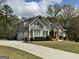 Charming home with a winding driveway, two-car garage, and meticulously maintained landscaping at 265 Beverly Farms Dr, Sharpsburg, GA 30277
