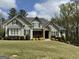 Beautiful two-story home featuring stone accents, manicured lawn, and lush landscaping at 265 Beverly Farms Dr, Sharpsburg, GA 30277