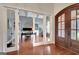 Elegant foyer with hardwood floors, a stone archway, and glass doors leading to office at 265 Beverly Farms Dr, Sharpsburg, GA 30277