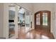 Elegant foyer with hardwood floors, a stone archway, and glass doors leading to office at 265 Beverly Farms Dr, Sharpsburg, GA 30277