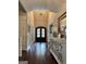This foyer features a high ceiling, a chandelier, hardwood floors, and natural light at 265 Beverly Farms Dr, Sharpsburg, GA 30277