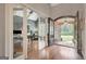 Welcoming foyer with hardwood floors, stone archway, and glass doors leading to a study at 265 Beverly Farms Dr, Sharpsburg, GA 30277