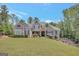 Charming two-story home with stone accents, beautiful landscaping, and a lush green lawn at 265 Beverly Farms Dr, Sharpsburg, GA 30277